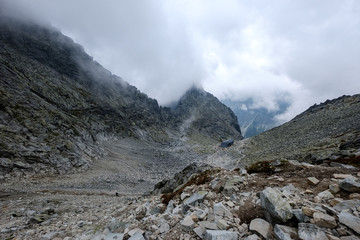 peak of Rysy mountain covered in mist. autumn ascent on hiking trails