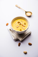 Kaddu or Pumpkin Kheer Or Bhoplyachi Kheer in Marathi and gummadikaya payasam in Telugu, Garnished with dry fruits. served in a bowl over moody background. Selective focus