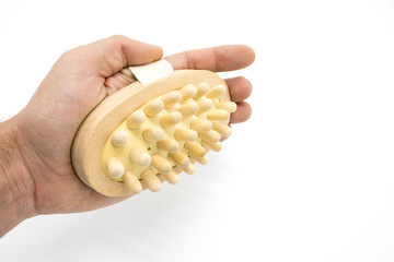 Massage comb from a tree with a belt on a hand