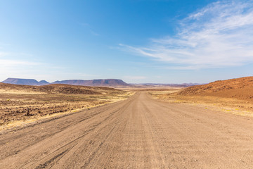 Fototapeta na wymiar Endless roads in a breathtaking landscape, Skeleton Coast Park, Namibia.