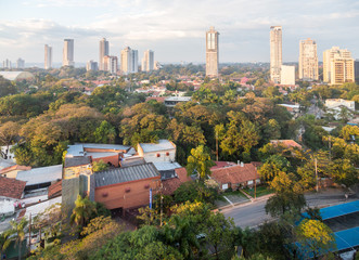 View of skyscrapers and villas in outer suburb district of Latin American capital of Asuncion city,...