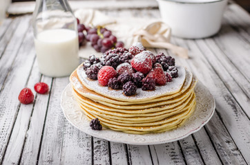 Homemade crepes with frozen berries, topped sugar