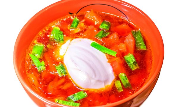 Homemade borsch soup on white background wth green speces