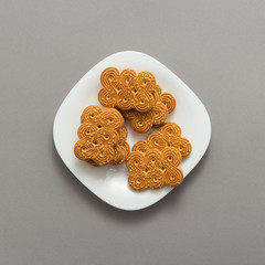 Tasty cookies biscuits on grey background, top view