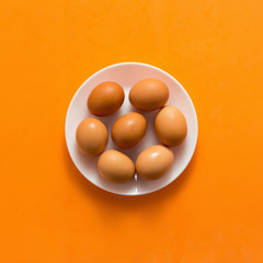 Egg, Chicken Eggs in plate on colored yellow background top view