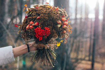 The autumn winter forest dried bouquet in woman hands, diy