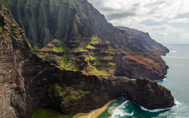 View of the monumental Na Pali Coast at Honopu Arch, aerial shot from a helicopter, Kauai, Hawaii.