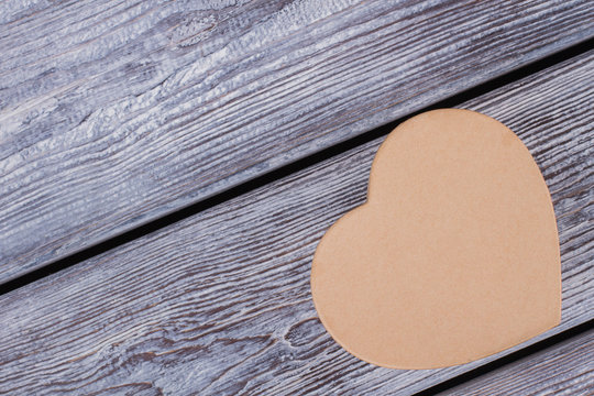 Plain paper heart shaped gift box. Brown cardboard gift box in a shape of heart, copy space.
