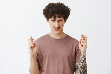 Guy believes in power of mind. Intense serious-looking determined and ambitious guy with curly...