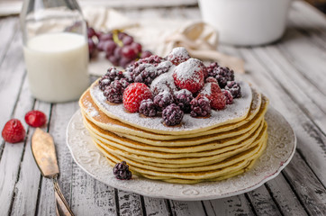 Homemade crepes with frozen berries, topped sugar