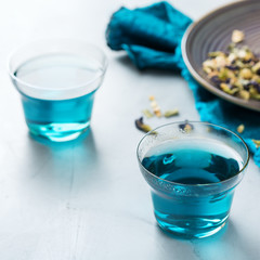 Blue butterfly pea flowers tea in a glass on table