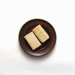 Plate with tasty pancakes on white background, top view, flat lay