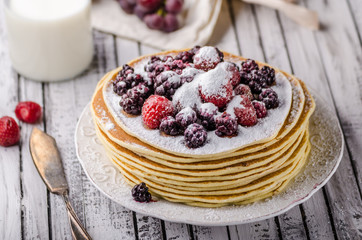 Homemade crepes with frozen berries, topped sugar