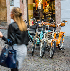 Neue alte Fahrräder zu verkaufen mit vorbeieilender Shopping Frau