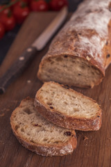 Appetizing sliced ciabatta bread  on wooden board. Toned photo
