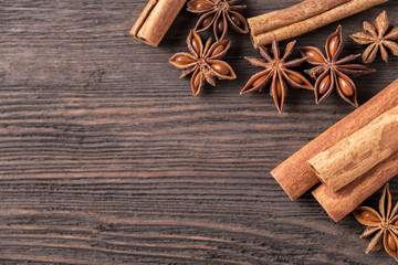 Anise star and  cinnamon sticks on wooden  background.  Top view