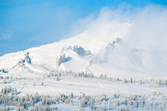 A cross on a mountain called Kurgan. These mountains are called Camels near the village of Sheregesh. Sheregesh is one of the most famous ski resorts in Russia.