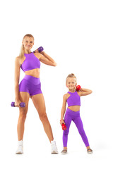 Mother trainer and kid girl doing fitness exercises with dumbbells on white background