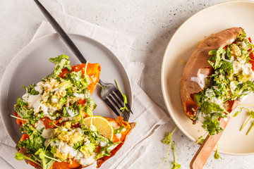 Quinoa Stuffed Sweet Potatoes with Kale and avocado, top view.
