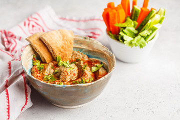 Middle Eastern cuisine: baba ganoush with vegetables in a plate on white background.