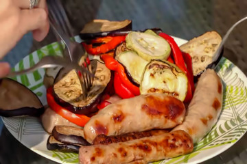 Abstract, blur, bokeh background, defocusing - image for the background. Eat sausages and grilled vegetables