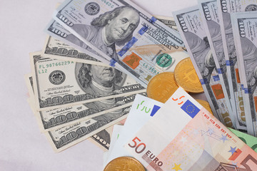 golden bitcoins new virtual currency with traditional dollars and euro as a background