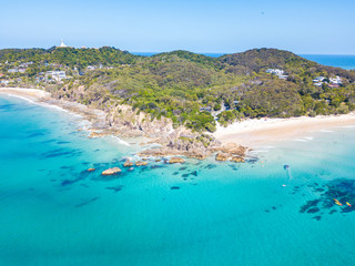 Fototapeta na wymiar The Pass and Wategoes at Byron Bay from an aerial view with blue water