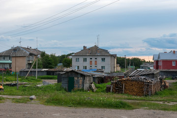 Fototapeta na wymiar ISLAND SOLOVKI, RUSSIA - JUNE 26, 2018: View of houses in the village of Solovki on a polar summer day, at sunset. Arkhangelsk region, White Sea