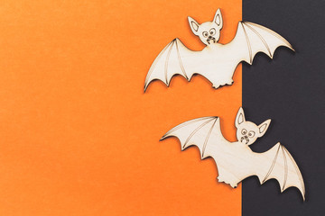 Do it yourself Halloween pumpkin and two vampire bats wooden cut outs on orange background