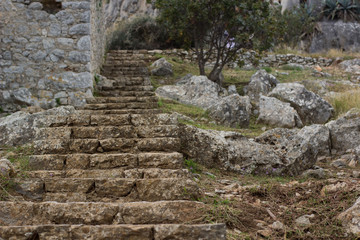 Fototapeta na wymiar stone stairs in destroyed ruins of old medieval castle castle