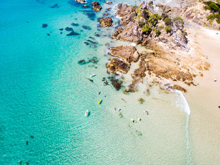 The Pass and Wategoes at Byron Bay from an aerial view with blue water