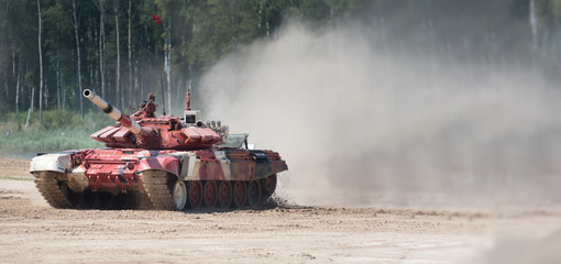 Fototapeta premium Army tank. Military training. Summer military exercises. Copyspace