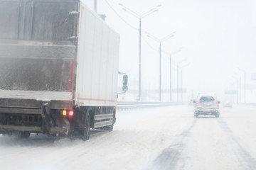 Winter Storm Traffic. Highway During Snow Storm. Heavy Snowfall and Heavy Traffic. truck or lorry on the road