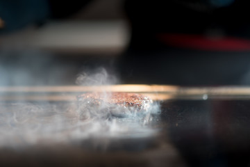 Hamburger cutlet frying on pan.Natural meet loaf pieces cooking in the kitchen.Burger sandwich meat being cooked with a lot of white smoke from a fat and oil.