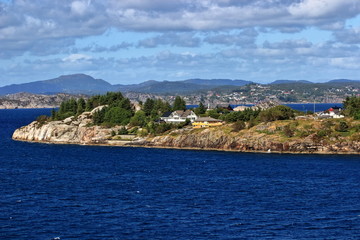Obraz premium A color image of the scenic Norwegian coastline as seen from the balcony of a cruise ship.