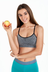 Diet concept. Proper nutrition. Beautiful slim girl holding in her hands fresh vegetables, greens, apple. studio, white background.
