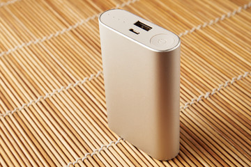 gray powerbank on wooden background