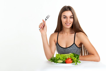 Diet concept. Proper nutrition. Beautiful slim girl holding in her hands fresh vegetables, greens, apple. studio, white background.
