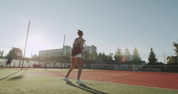 Two friends ladies playing professional tennis on the tennis court outside, full game capturing.