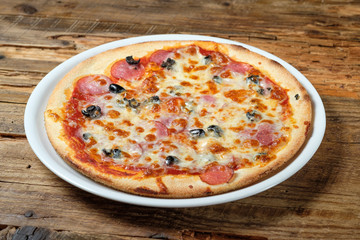 Pizza with tomato sauce, salami and olives
