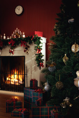 view of wrapped gifts with christmas tree and fireplace  on the back