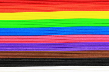 A closeup color image of a stack of multi colored foam board.