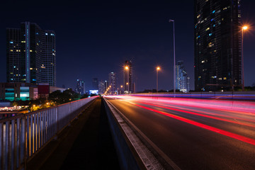 Beautiful of light trails on the street and urban at dusk as city life background.