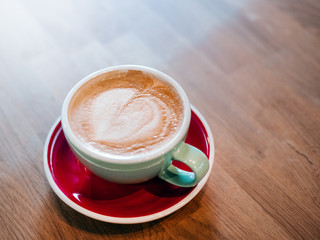 latte on wooden desk in retro film filter effect