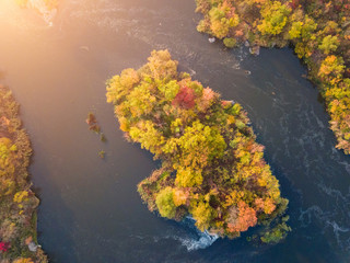 aerial drone view of colorful forest, blue river and rocks. beautiful autumn landscape