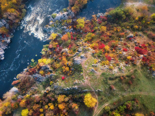 aerial drone view of colorful forest, blue river and rocks. beautiful autumn landscape