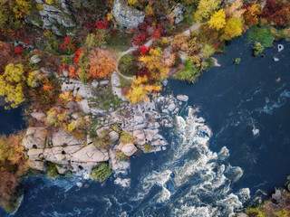 Naklejka na ściany i meble aerial drone view of colorful forest, blue river and rocks. beautiful autumn landscape