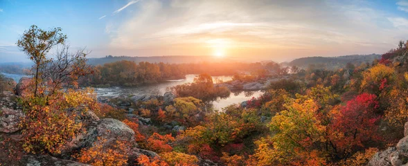 Fototapeten Erstaunlicher Panoramablick auf den blauen nebligen Fluss und den bunten Wald bei Sonnenaufgang. Herbstlandschaft © ver0nicka