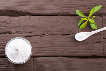 Natural sweetener in powder from stevia plant - Stevia rebaudiana. Top view