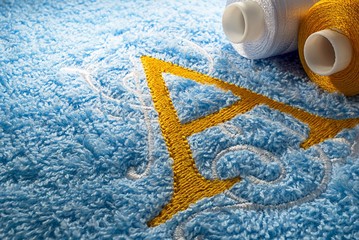 Embroidery alphabet design on towel, close up